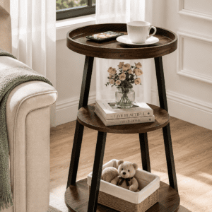 Rustic three-tier round end table with wood shelves and black metal legs beside a cozy sofa in a modern living room