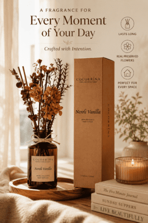 Luxury Neroli Vanilla reed diffuser with preserved flowers in an amber glass bottle, creating an elegant home fragrance display in a cozy living room.