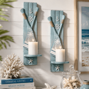 Coastal paddle wall candle sconce set with blue wooden paddles, nautical accents, and white pillar candles for beach house wall décor.