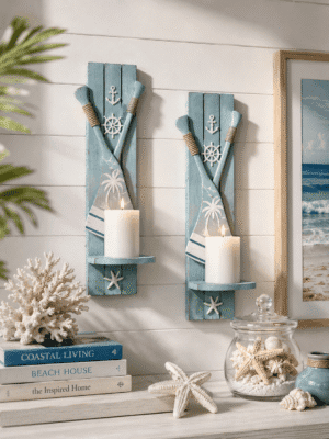 Coastal paddle wall candle sconce set with blue wooden paddles, nautical accents, and white pillar candles for beach house wall décor.