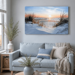 Coastal beach sunset canvas wall art featuring ocean waves, sandy dunes, and a peaceful sunset displayed above a modern living room sofa.