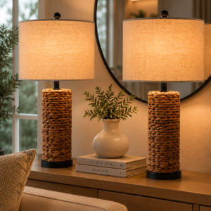 Set of two woven table lamps with linen fabric shades on a wooden console table in a cozy neutral living room.