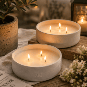 Luxury triple wick soy wax outdoor candles in minimalist ceramic bowls styled on a wooden table with lanterns and greenery on a cozy patio.