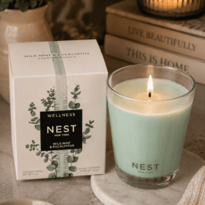 NEST New York Wild Mint & Eucalyptus luxury scented candle in a glass jar with decorative gift box, marble tray, and elegant home décor.