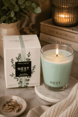 NEST New York Wild Mint & Eucalyptus luxury scented candle in a glass jar with decorative gift box, marble tray, and elegant home décor.