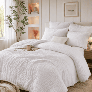 White textured comforter bedding set styled in a cozy modern farmhouse bedroom with woven pendant light, wood ceiling beams, soft neutral decor, and warm natural lighting.