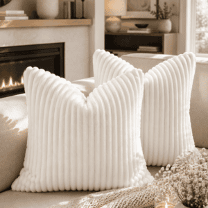 Luxury white ribbed plush throw pillow covers on a neutral sofa with a knitted throw blanket, fireplace, candlelight, and modern organic living room décor.